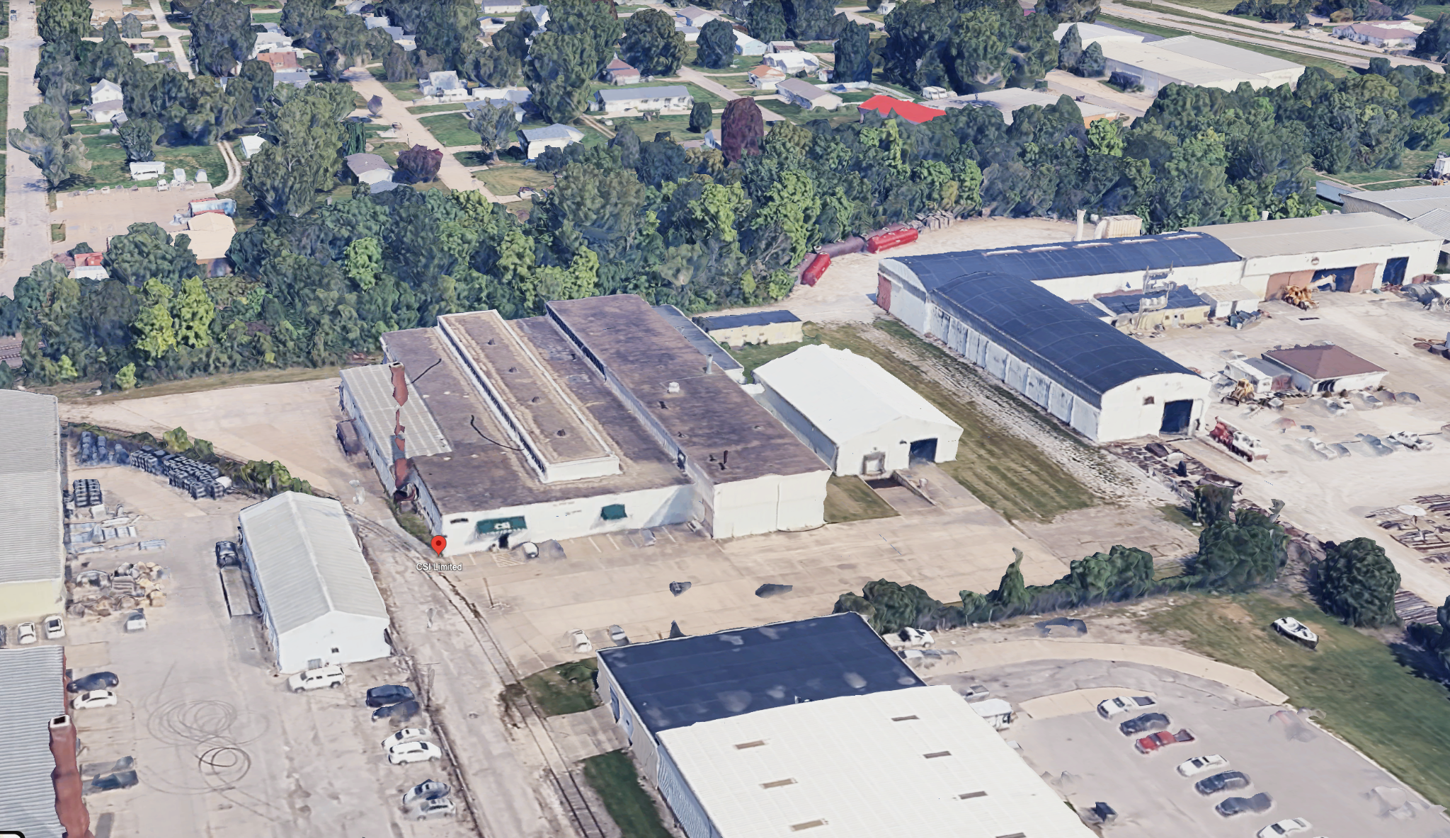 Oblique aerial overview of the CSI Industries facility and surrounding industrial grounds